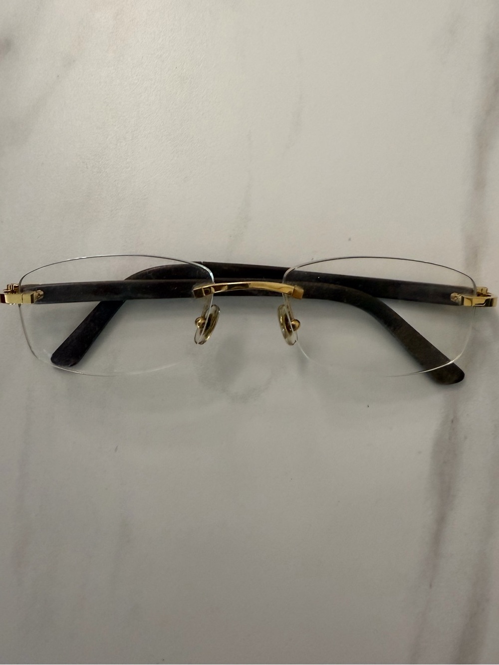 Cartier Rimless Glasses with Gold Accents and Black Temples